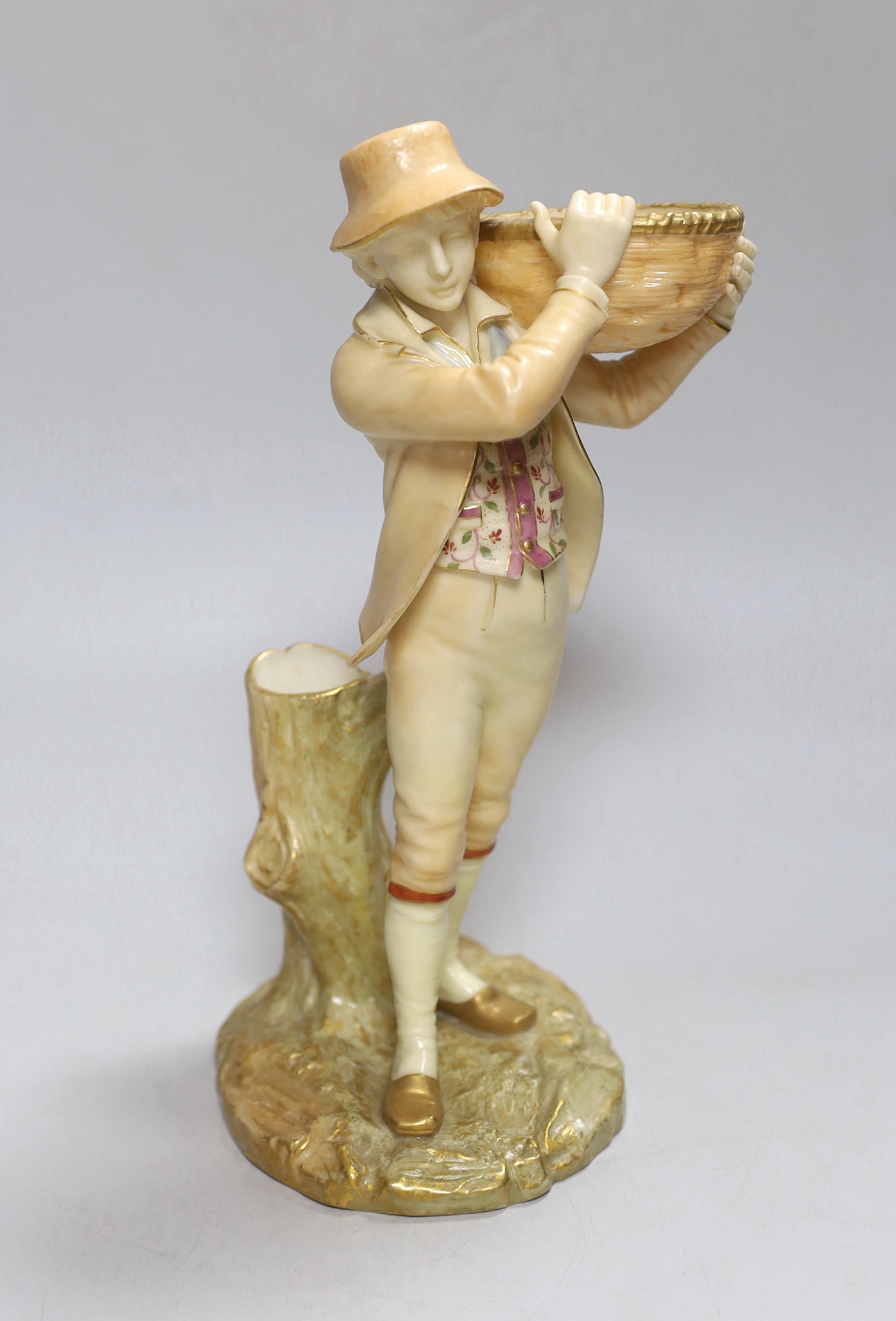 A Royal Worcester figure of a boy, highlighted in gold, with a wicker basket in his hands, painted in blush ivory, shape 880, date mark 1899, 24cm high